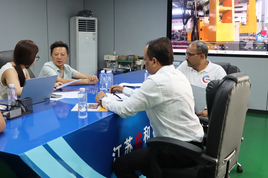 Telhoo team negotiating a pipe bending machine order with overseas buyers